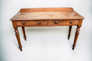 A Victorian mahogany parlour two drawer desk with gallery back, wooden knob handles and turned legs,