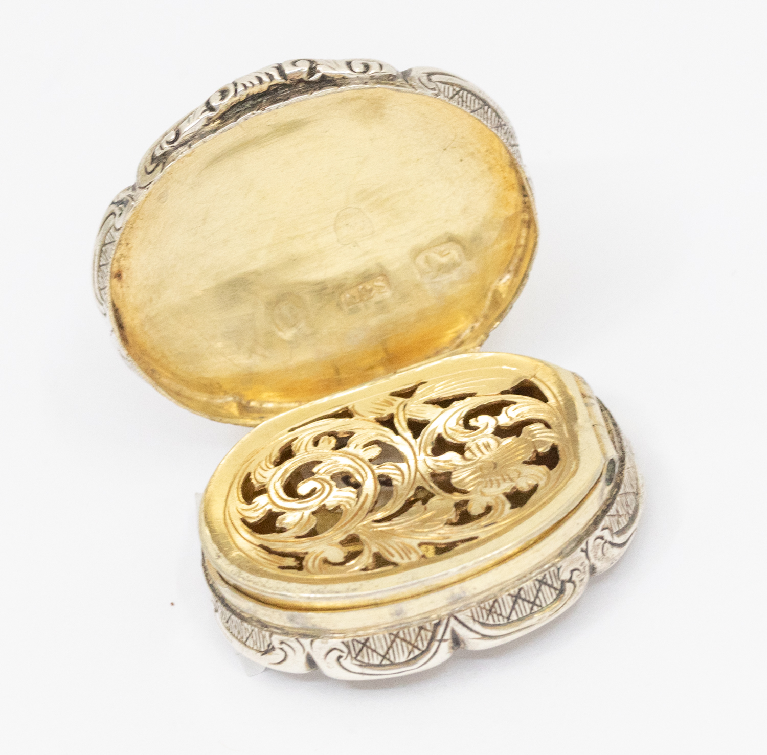 A Victorian silver shaped oval vinaigrette, scalloped border, engraved with flowers and foliage, the - Image 2 of 3