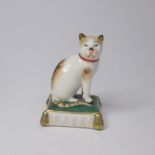 An Emile Samson cat seated on a cushion. Date; late 19th Century Size Height; 7cm, width 5cm