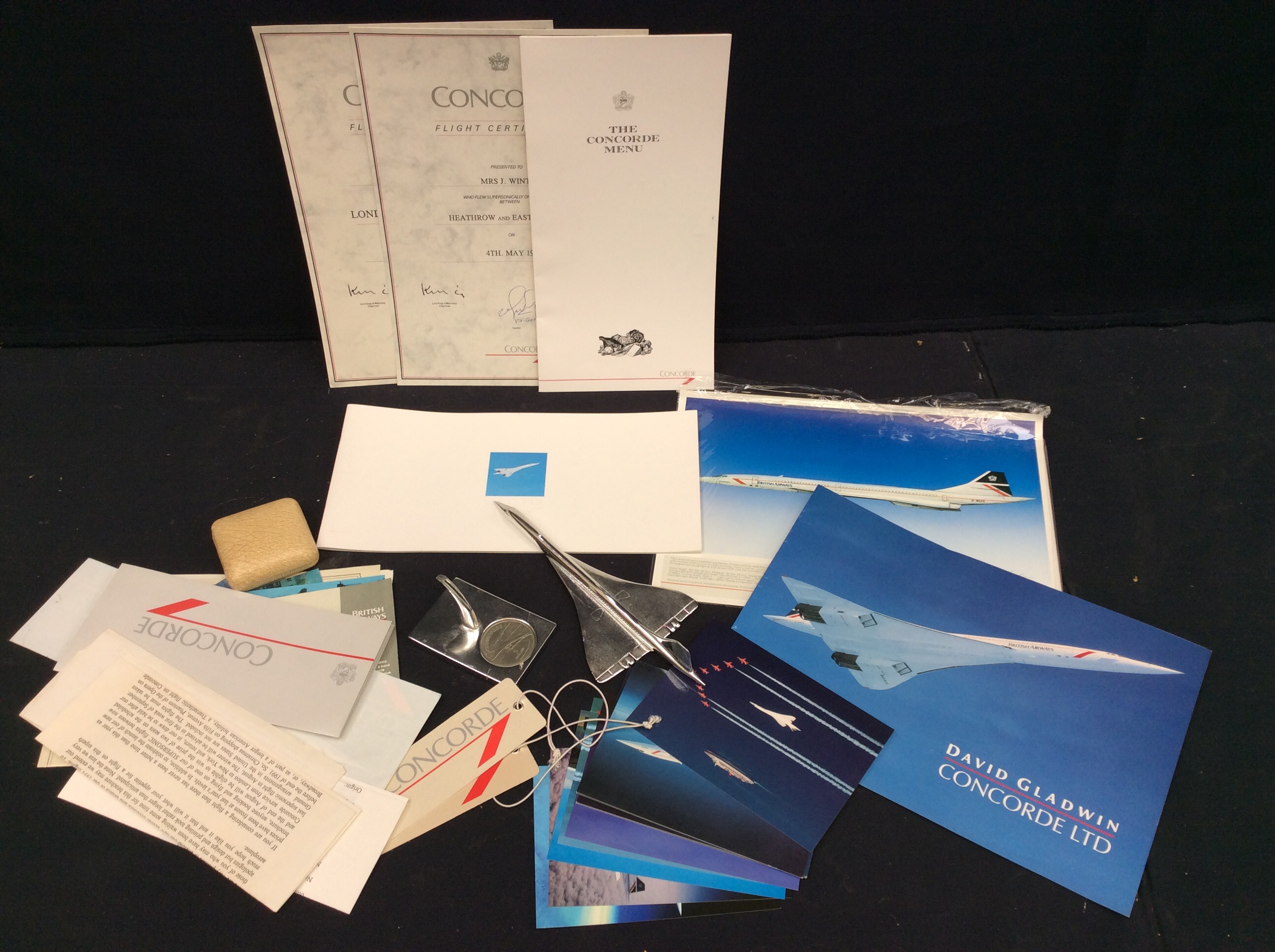 A collection of mixed Concorde memorabilia to include; a Royal Mint 'Classics' model of Concorde (