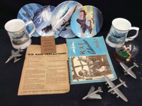 A collection of WWII cabinet plates and tankards, model planes and other WWII ephemera.