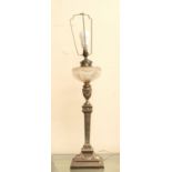 A late 19th Century silver plated columned oil lamp with ribbed and swag design, with cut glass