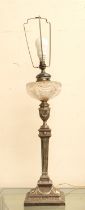 A late 19th Century silver plated columned oil lamp with ribbed and swag design, with cut glass