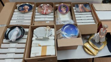 A collection of Marilyn Monroe ephemera to include telephone, cabinet plates . 9 boxes sold as seen