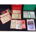 A 20th century Mahjong set in red paper case, pieces made of bone, different coloured pieces, along