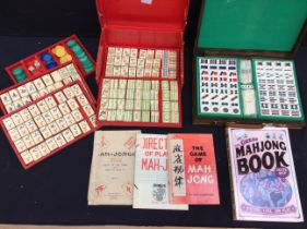 A 20th century Mahjong set in red paper case, pieces made of bone, different coloured pieces, along