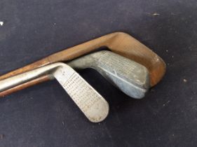 Three vintage golf clubs, early 20th Century, all with makers name.