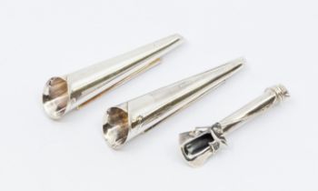Boutonnieres: a collection of three novelty silver buttonhole posy holders, two matching large plain
