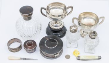 A collection of silver items to include; a pair of small twin handled George V silver trophies, each