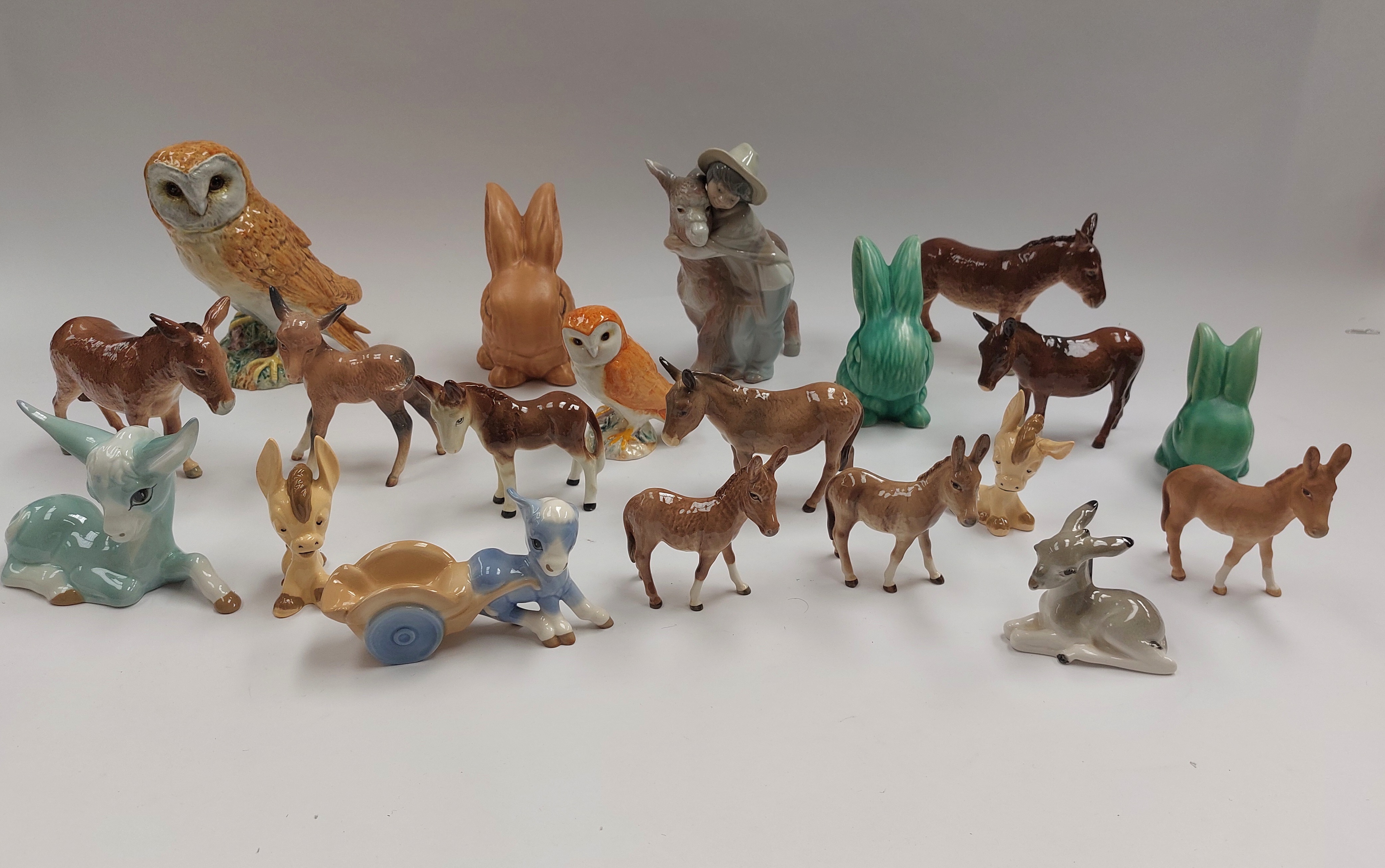 A collection of Beswick donkey figurines, together with Wade Heath rabbits, various other factory