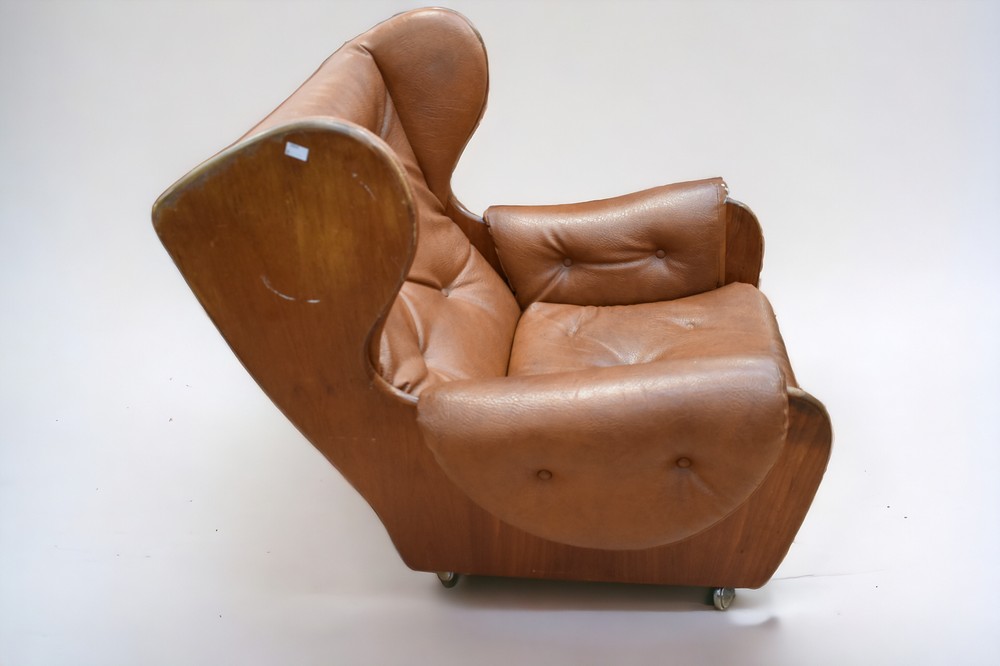 An early 1970s teak and leatherette button back lounge armchair on castors. - Image 4 of 6