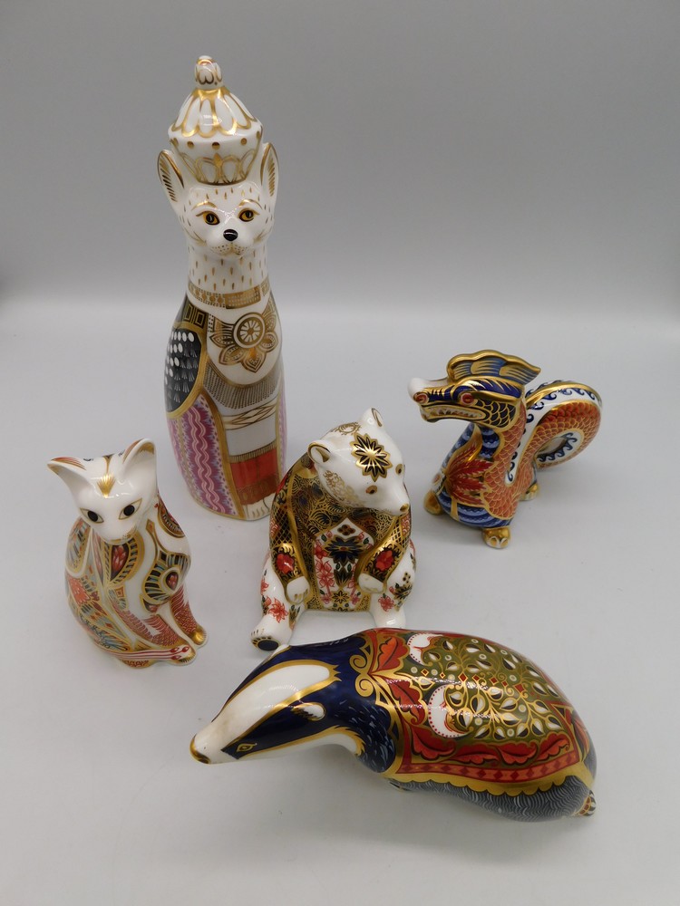 Four unboxed Royal Crown Derby paperweights - Dragon, Bear, Royal Cat and Cat - and a boxed Badger