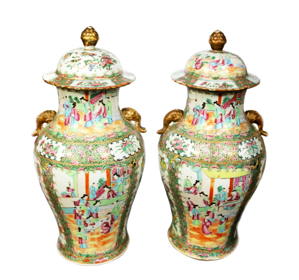 A pair of late 19th century Cantonese famille rose lidded vases, with elephant trunk handles and