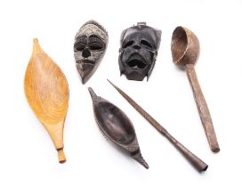 A collection of African treen items to include masks, bowls and water spoon along with a spearhead.