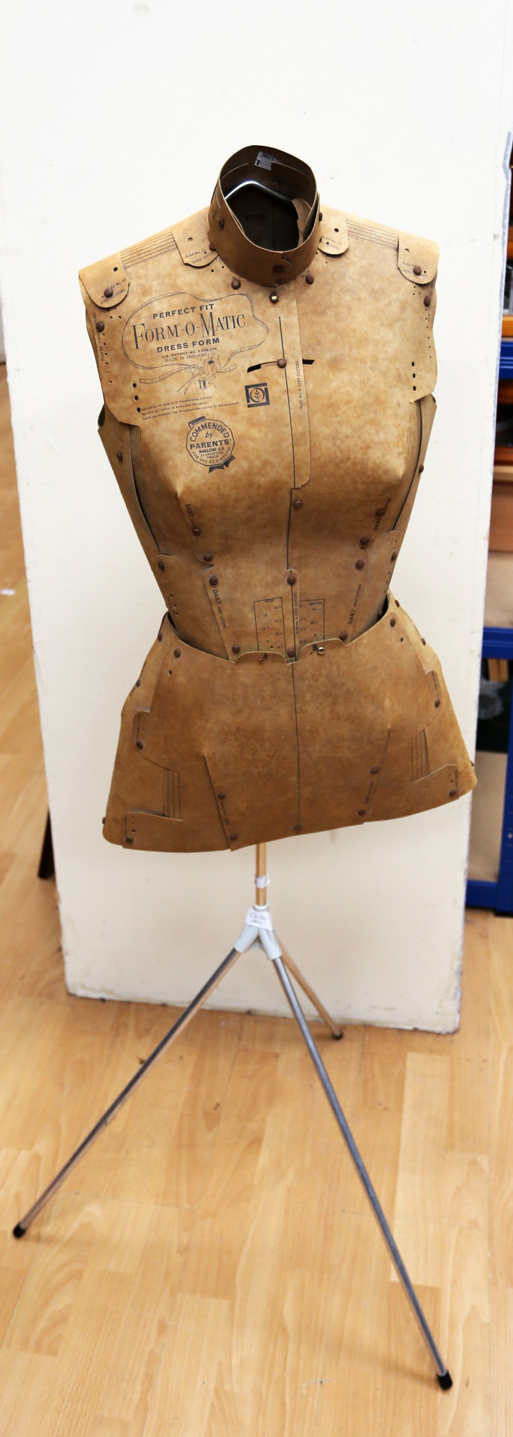 A vintage heavy duty cardboard tailors dummy with measurements printed onto the form, made by