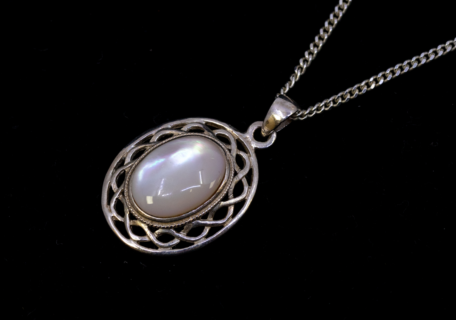A moonstone and silver pendant, pendant approx 24mm not including bale, chain approx 18'' Further