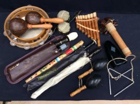 A collection of musical instruments to include recorders, tambourines, pan pipes, triangle, rain