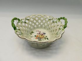 A Chelsea red anchor twin handled pierced chestnut basket, the inside centre painted with floral