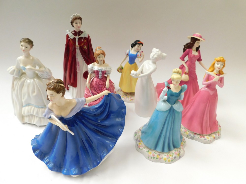 A collection of 9 figurines , to include 3 Royal Doulton Disney series figures, Sleeping Beauty,