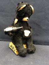 A 1950s battery operated advertising bear with Pepsi cola bottle and beaker.