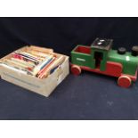 A collection of vintage road maps and a child's wooden train.