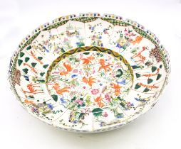 A modern Chinese large famille verte circular bowl, cut card border with deep recess to centre,