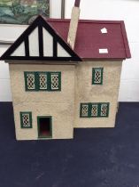 A 1920s dolls house with furniture, metal windows and rendered all around.