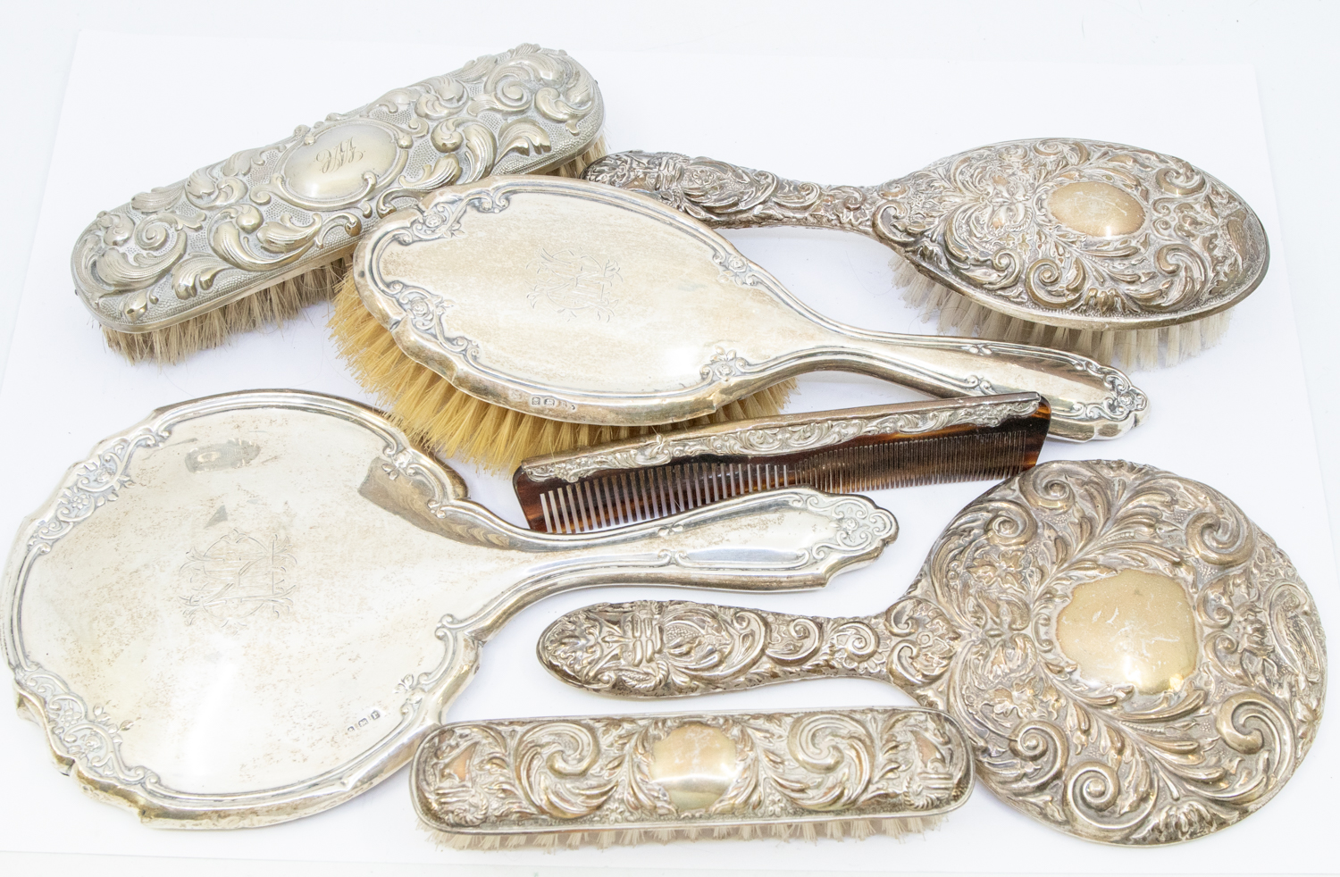 A collection of silver dressing table items to include; a matching Elizabeth II set consisting of