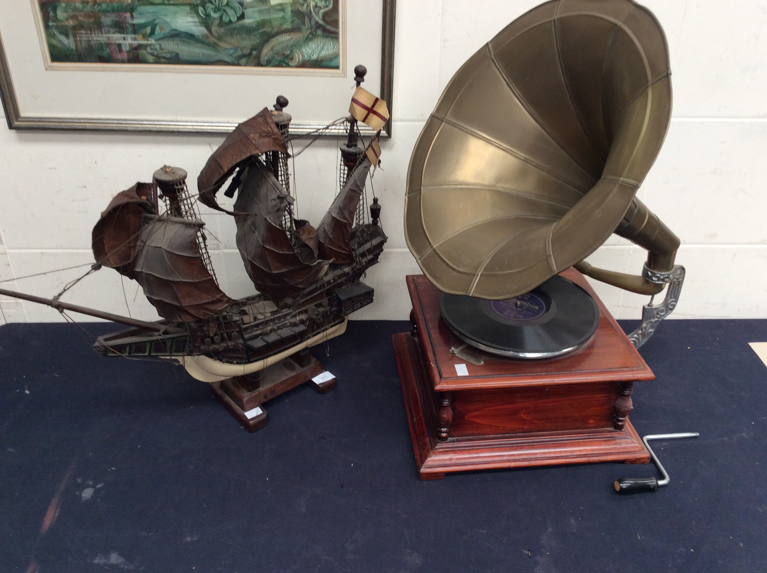 A reproduction table top gramophone along with a mid 20th Century model ship.