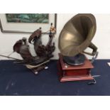 A reproduction table top gramophone along with a mid 20th Century model ship.