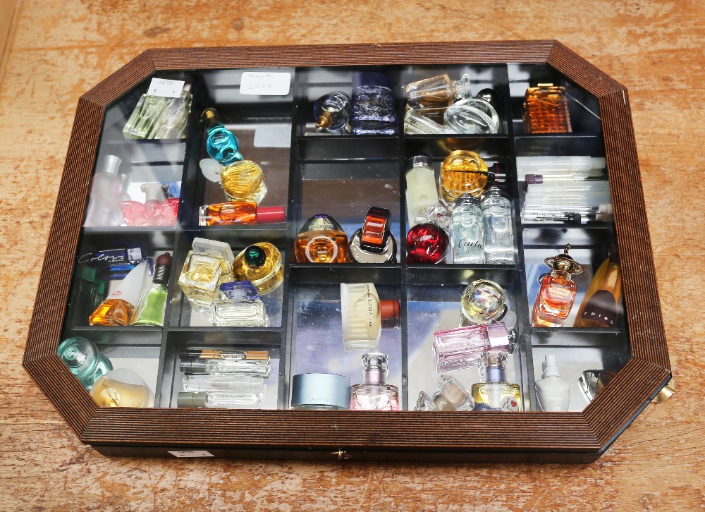 A collection of thirty-nine miniature perfume bottles and samples, comprising vintage and later