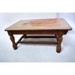 A large substantial Victorian pitch pine kitchen table with thick bluster legs, 177cm x 110cm x