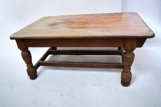 A large substantial Victorian pitch pine kitchen table with thick bluster legs, 177cm x 110cm x