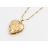 A gold front & back heart-shaped locket, suspended from a unmarked fancy link chain, combined weight