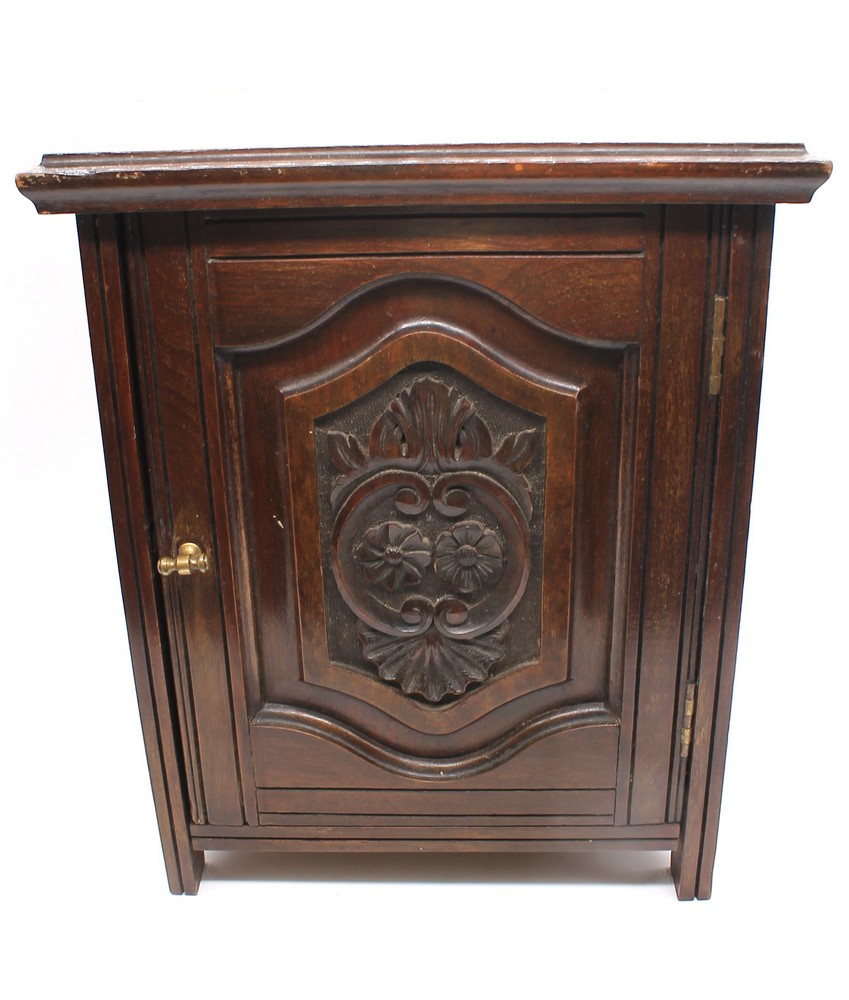 Oak late 19th century early 20th century tobacco cupboard with carved front.