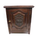 Oak late 19th century early 20th century tobacco cupboard with carved front.