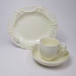 A Creamware oval dish with a reticulated rim and a creamware cup and saucer with a twisted strap