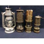 An Eccles miners lamp, small lamp and Limelight Company lamp, W.E Teale & Co lamp and an oil lamp.