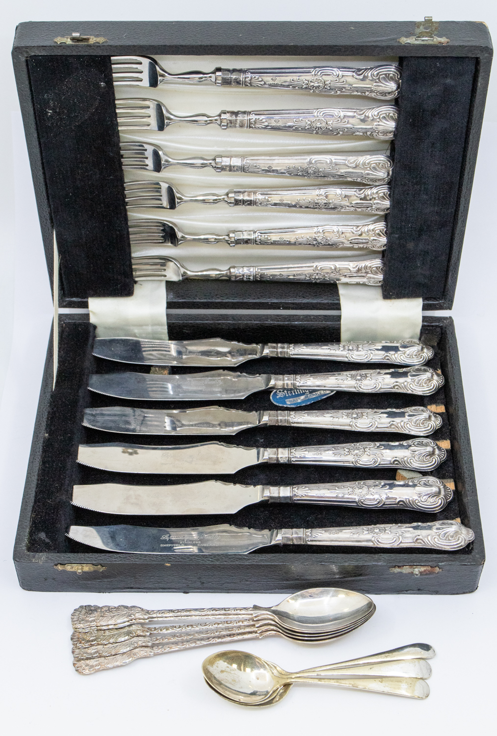 A cased set of Elizabeth II silver handled dessert knives and forks, superior quality stainless