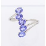 A tanzanite and 9ct white gold ring, comprising a row of five oval mixed cut stones, claw set to a