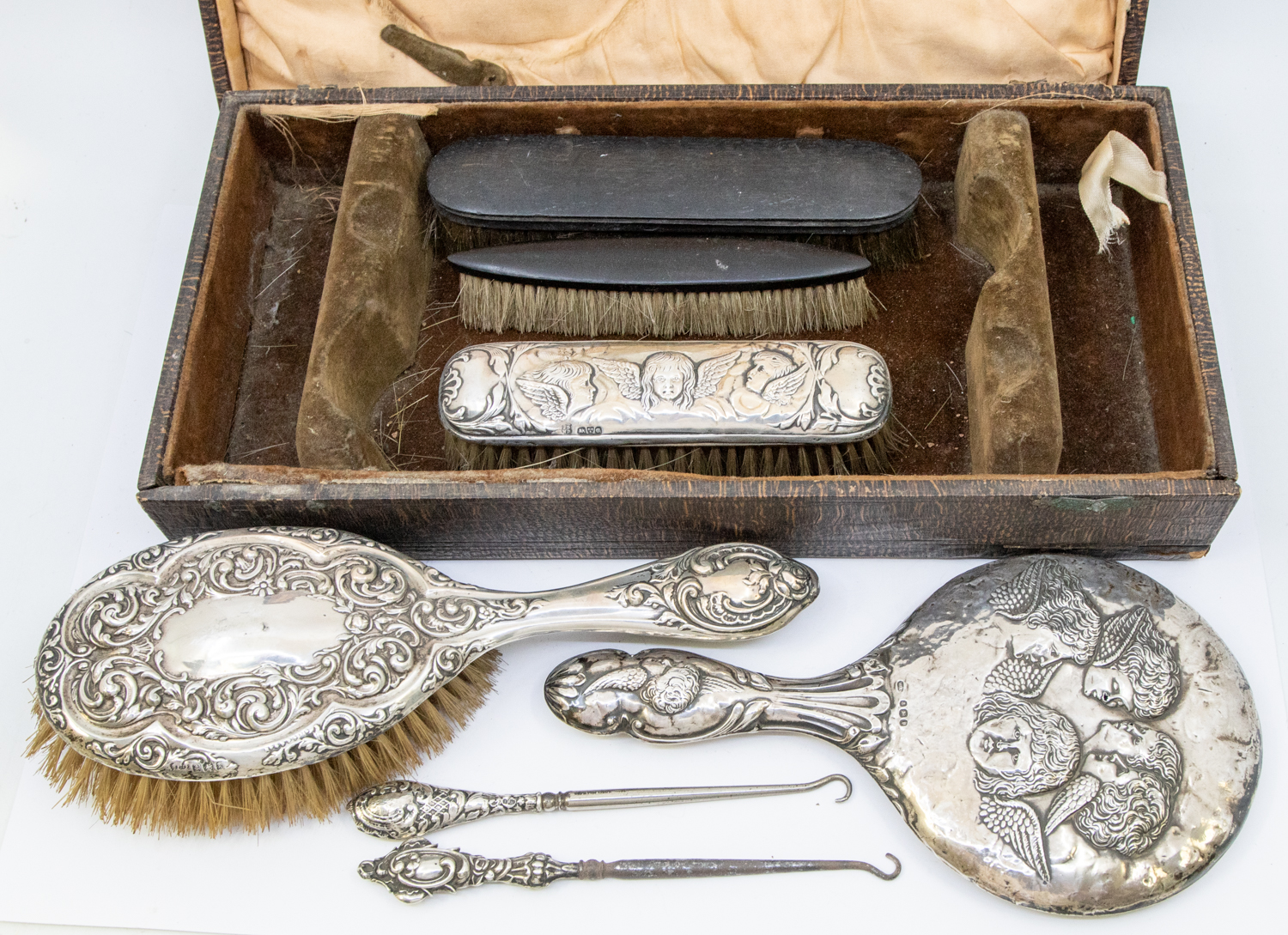 A mixed collection of silver dressing table items to include; a Birmingham silver hand mirror with