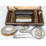 A mixed collection of silver dressing table items to include; a Birmingham silver hand mirror with