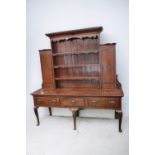 A George III oak dresser with three drawers to base with brass ornaye handles, cabriole legs with