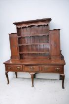 A George III oak dresser with three drawers to base with brass ornaye handles, cabriole legs with