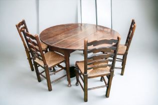 An early 18th Century English solid oak dropleaf dining table with planked top, tapered legs and