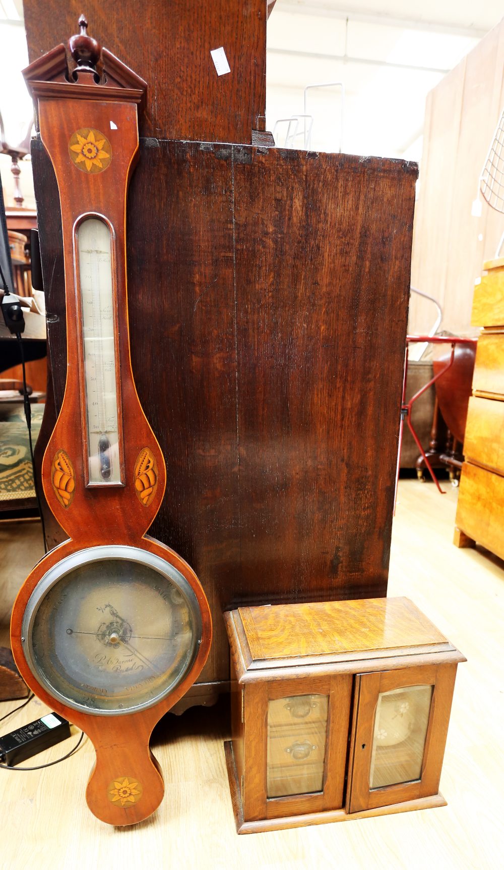 An Edwardian banjo barometer in mahogany along with an Edwardian smokers cabinet.