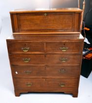 A George III oak chest of two above three drawers with brass swing handles on bracket feet along