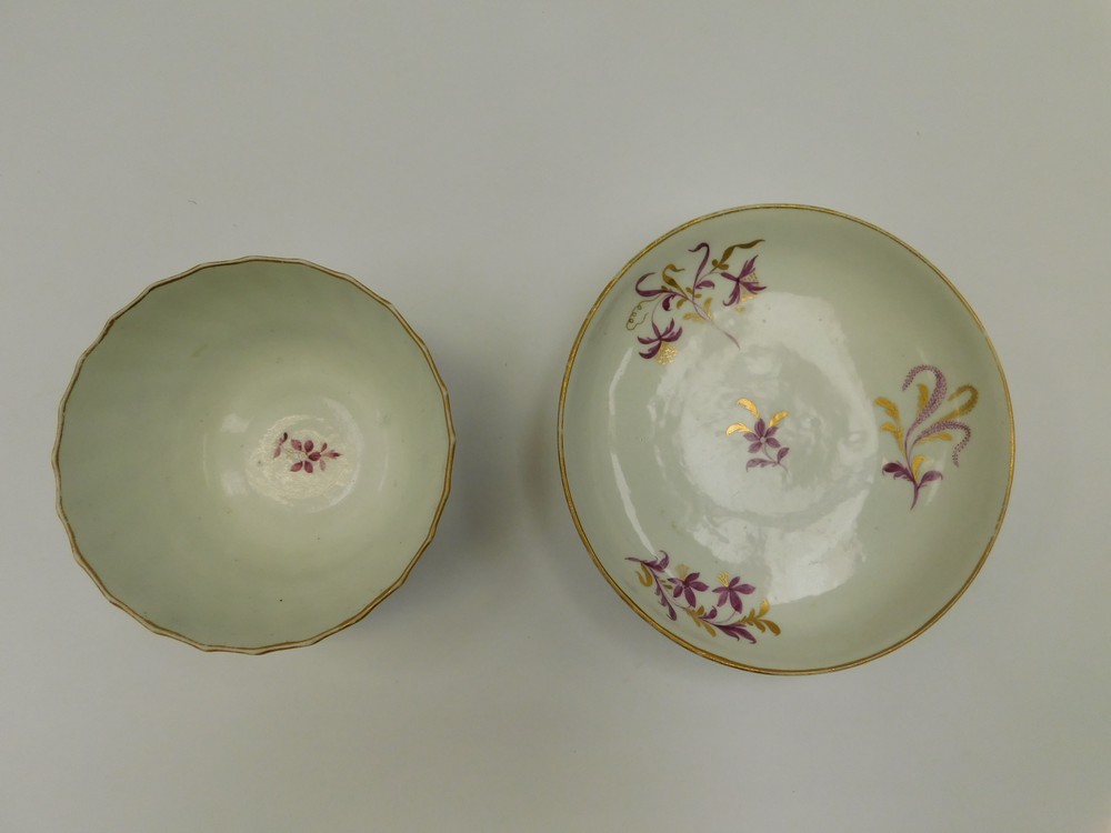 A Worcester tea bowl and saucer. Puce and gilt floral decorated, tea bowl has a twisted fluted body. - Image 2 of 2