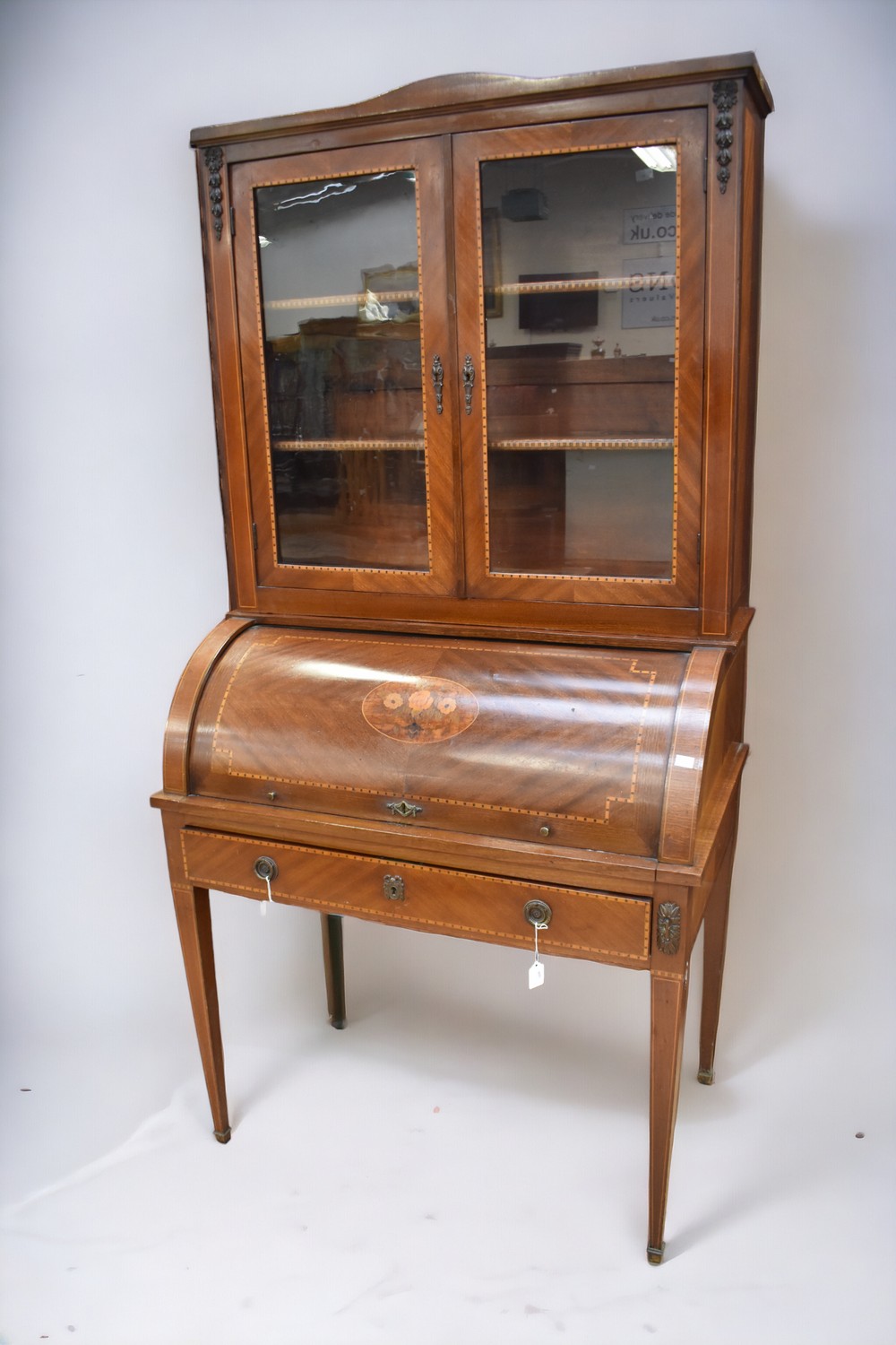 An Edwardian glazed writing bureau with cabinet top and inlaid design.