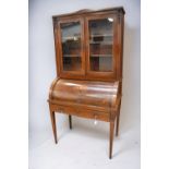An Edwardian glazed writing bureau with cabinet top and inlaid design.